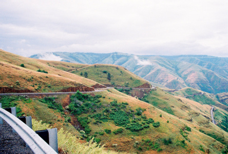 [The road as it winds around the mountain at the same level as the camera. There is a little in the photo of the roadway at the lower levels in the canyon.]